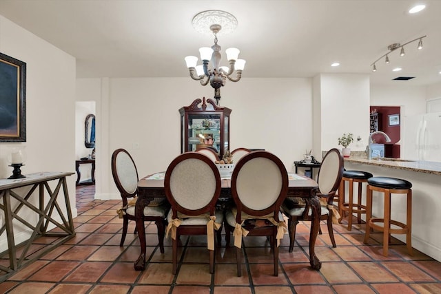 dining area featuring a chandelier, tile patterned flooring, baseboards, and recessed lighting