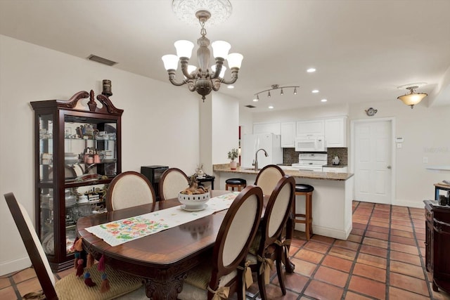 dining space with visible vents, recessed lighting, a chandelier, light tile patterned floors, and baseboards