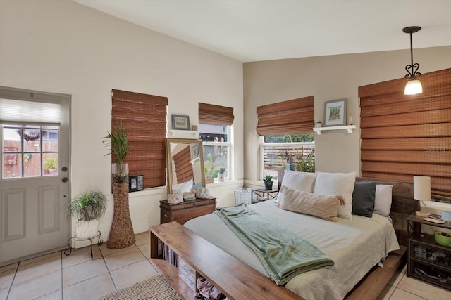 bedroom with vaulted ceiling and light tile patterned flooring
