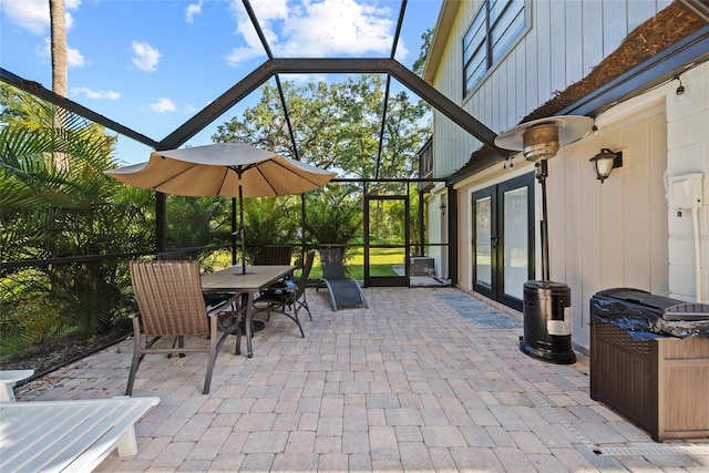 7101 N 18th St, Tampa, FL 33610 - view of patio / terrace with french doors, a lanai, outdoor dining space, and a hot tub