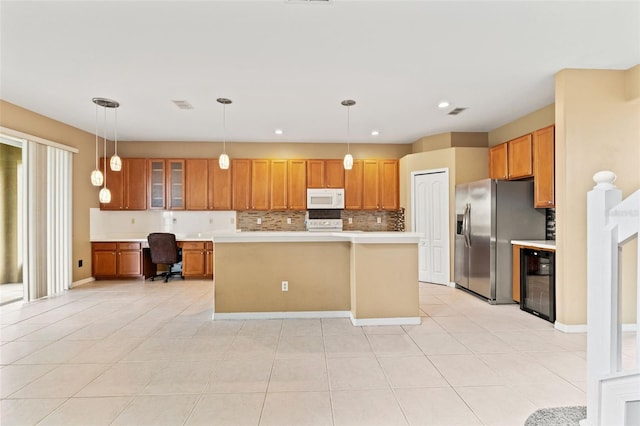 4335 Canongate Ct, Spring Hill, FL 34609 - kitchen featuring white microwave, stainless steel refrigerator with ice dispenser, decorative backsplash, light countertops, and brown cabinets