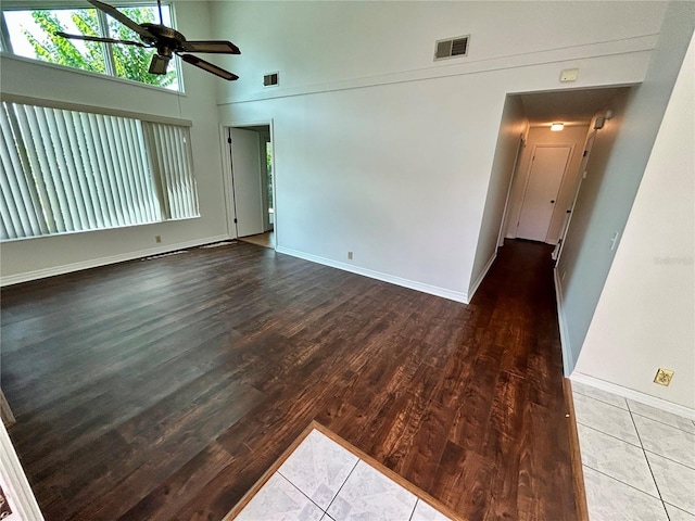 7444 Candlelight Ct, New Port Richey, FL 34652 - empty room with ceiling fan, wood finished floors, and a high ceiling