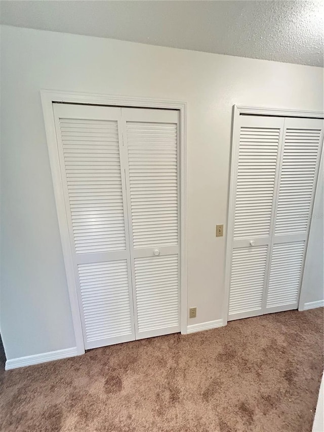 7444 Candlelight Ct, New Port Richey, FL 34652 - unfurnished bedroom with carpet floors and two closets