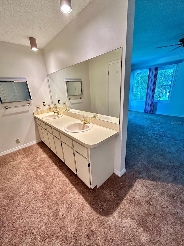 7444 Candlelight Ct, New Port Richey, FL 34652 - bathroom with carpet floors, a textured ceiling, and double vanity