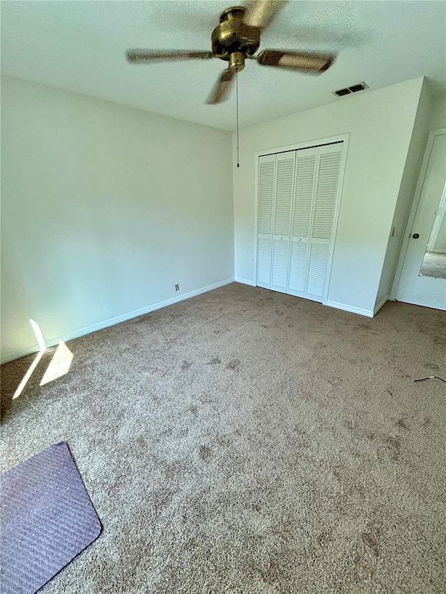 7444 Candlelight Ct, New Port Richey, FL 34652 - unfurnished bedroom with a closet, carpet, and a ceiling fan