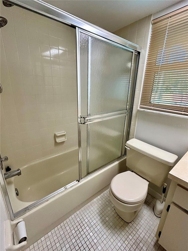7444 Candlelight Ct, New Port Richey, FL 34652 - bathroom with vanity, enclosed tub / shower combo, and tile patterned floors