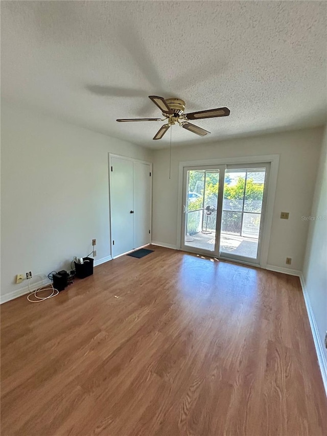 7444 Candlelight Ct, New Port Richey, FL 34652 - spare room with a textured ceiling, ceiling fan, and wood finished floors