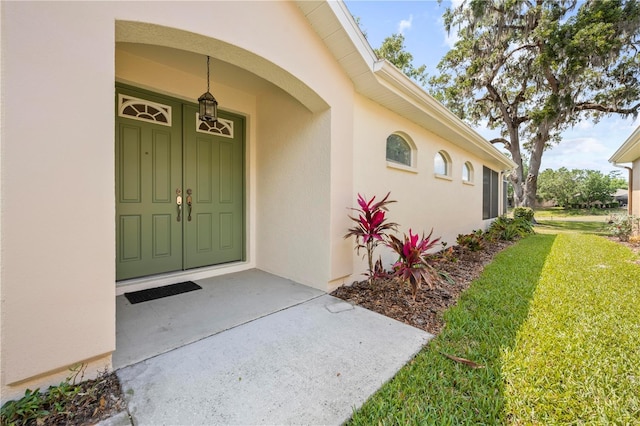 4407 Caliquen Dr, Brooksville, FL 34604 - doorway to property with a yard and stucco siding