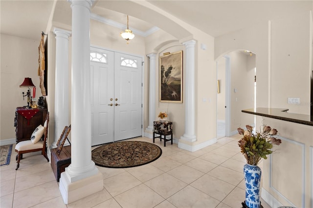 4407 Caliquen Dr, Brooksville, FL 34604 - foyer entrance with light tile patterned floors, ornate columns, and arched walkways