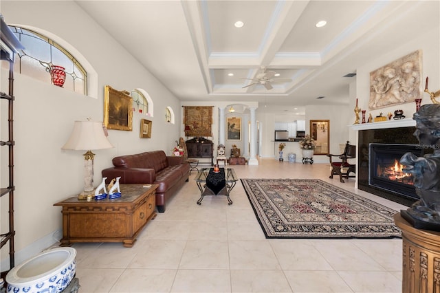 4407 Caliquen Dr, Brooksville, FL 34604 - living area featuring decorative columns, a fireplace with flush hearth, a ceiling fan, coffered ceiling, and tile patterned floors