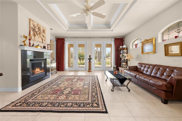 4407 Caliquen Dr, Brooksville, FL 34604 - living room featuring a ceiling fan, tile patterned flooring, a tile fireplace, a raised ceiling, and french doors