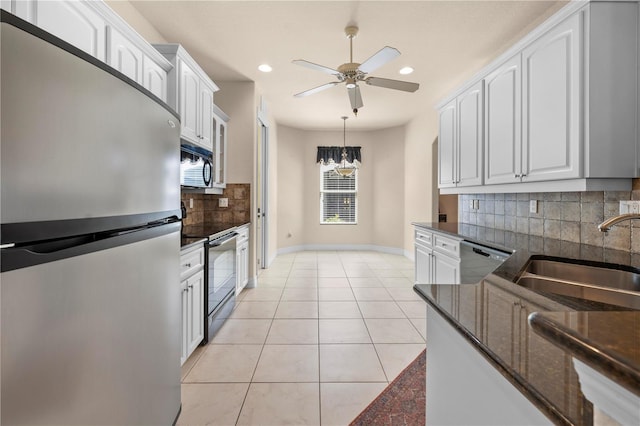 4407 Caliquen Dr, Brooksville, FL 34604 - kitchen with tasteful backsplash, white cabinets, a sink, a ceiling fan, and stainless steel appliances