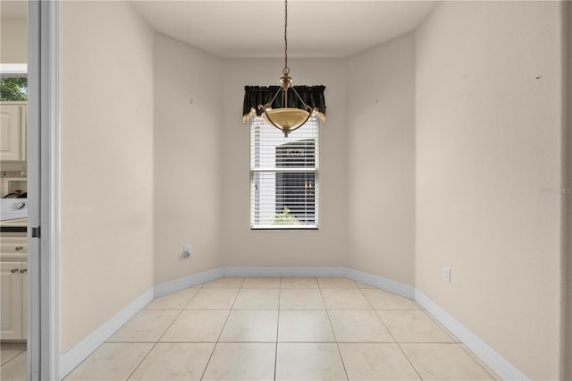 4407 Caliquen Dr, Brooksville, FL 34604 - unfurnished dining area featuring plenty of natural light, baseboards, an inviting chandelier, and light tile patterned flooring