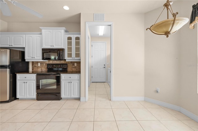 4407 Caliquen Dr, Brooksville, FL 34604 - kitchen with tasteful backsplash, white cabinetry, visible vents, black appliances, and light tile patterned flooring