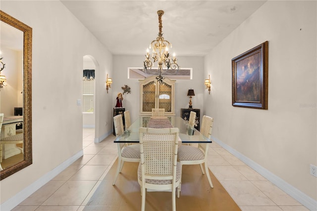 4407 Caliquen Dr, Brooksville, FL 34604 - dining space with a chandelier, arched walkways, light tile patterned flooring, and baseboards