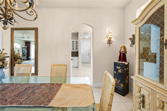 4407 Caliquen Dr, Brooksville, FL 34604 - dining space featuring baseboards, light tile patterned floors, visible vents, ceiling fan, and arched walkways