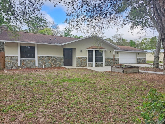 18232 Monteverde Dr, Spring Hill, FL 34610 - back of property with fence, stone siding, a garage, and stucco siding