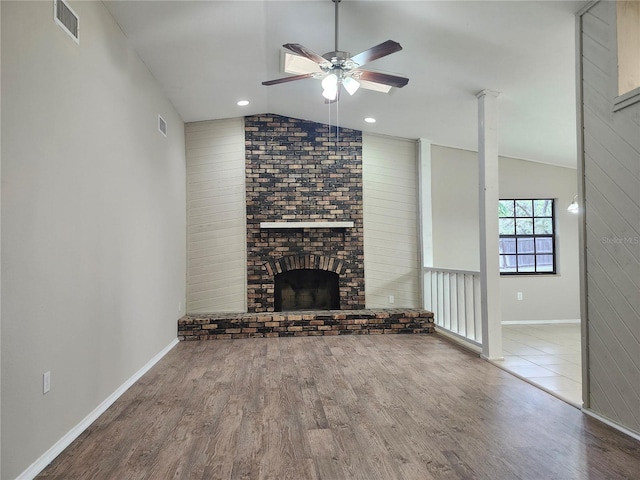 18232 Monteverde Dr, Spring Hill, FL 34610 - unfurnished living room featuring baseboards, a brick fireplace, ceiling fan, wood finished floors, and lofted ceiling