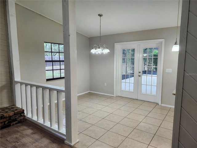18232 Monteverde Dr, Spring Hill, FL 34610 - unfurnished dining area with french doors, baseboards, and an inviting chandelier