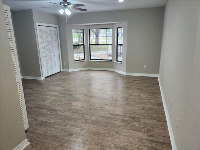 18232 Monteverde Dr, Spring Hill, FL 34610 - unfurnished bedroom with a closet, dark wood-style flooring, baseboards, and a ceiling fan
