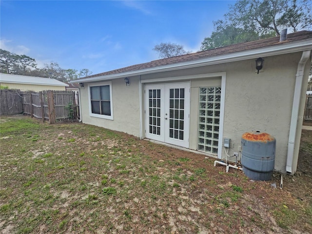 18232 Monteverde Dr, Spring Hill, FL 34610 - rear view of house with french doors, stucco siding, and fence
