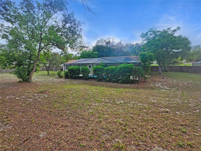 18232 Monteverde Dr, Spring Hill, FL 34610 - view of yard with glass enclosure and fence