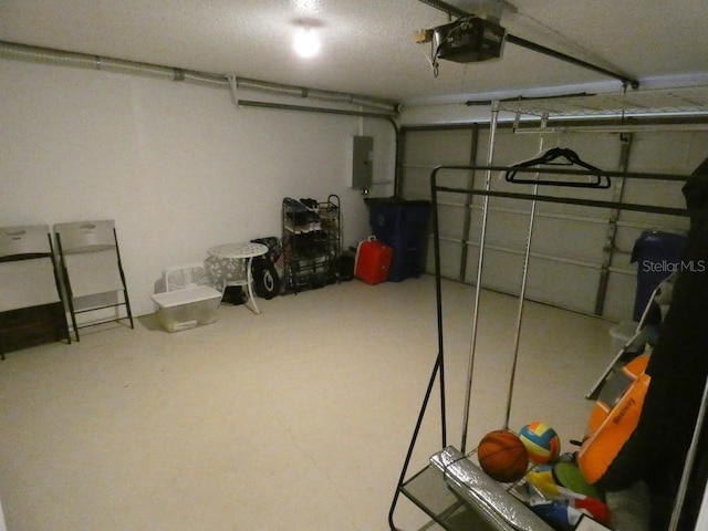 garage with a garage door opener and electric panel