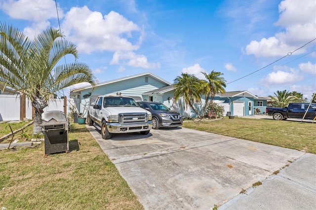 13815 Plumosa Ave, Hudson, FL 34667 - view of front facade featuring a front yard, fence, and driveway