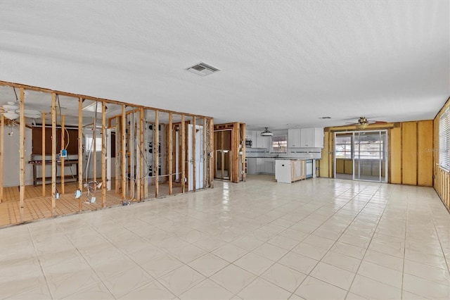 13815 Plumosa Ave, Hudson, FL 34667 - unfurnished living room featuring visible vents, a ceiling fan, and light floors