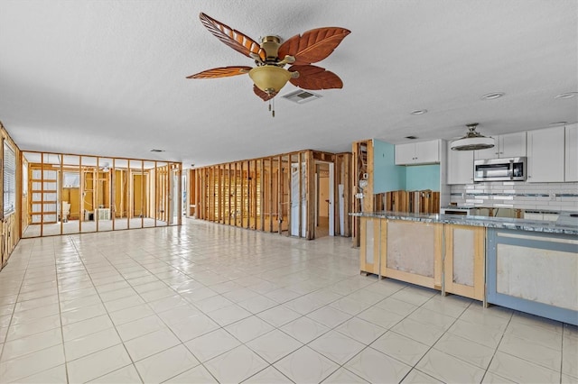 13815 Plumosa Ave, Hudson, FL 34667 - unfurnished living room with visible vents and ceiling fan