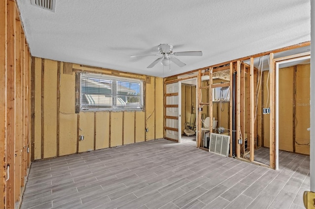 13815 Plumosa Ave, Hudson, FL 34667 - miscellaneous room featuring a textured ceiling, wood finished floors, a ceiling fan, and visible vents