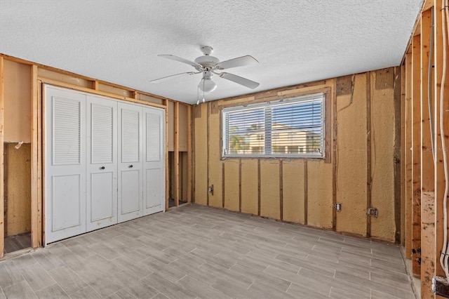 13815 Plumosa Ave, Hudson, FL 34667 - unfurnished bedroom featuring light wood-type flooring, a closet, ceiling fan, and a textured ceiling