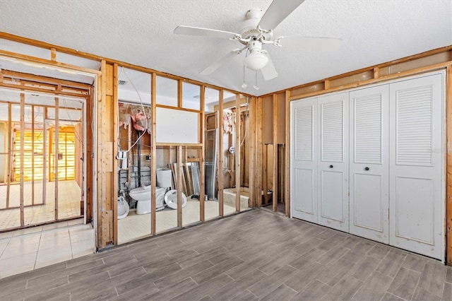13815 Plumosa Ave, Hudson, FL 34667 - unfurnished bedroom featuring a ceiling fan, wood finished floors, and a textured ceiling