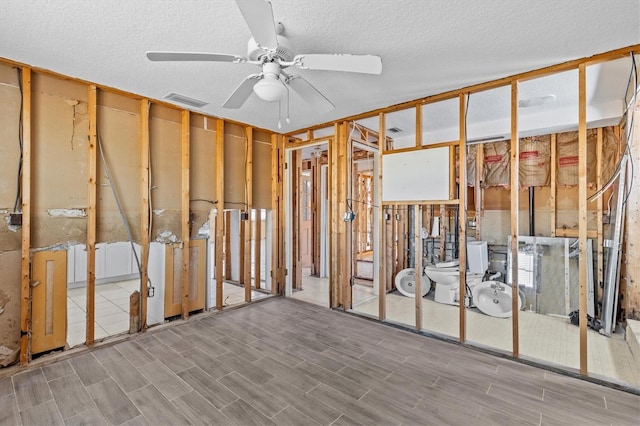 13815 Plumosa Ave, Hudson, FL 34667 - miscellaneous room featuring visible vents, a textured ceiling, wood finished floors, and ceiling fan