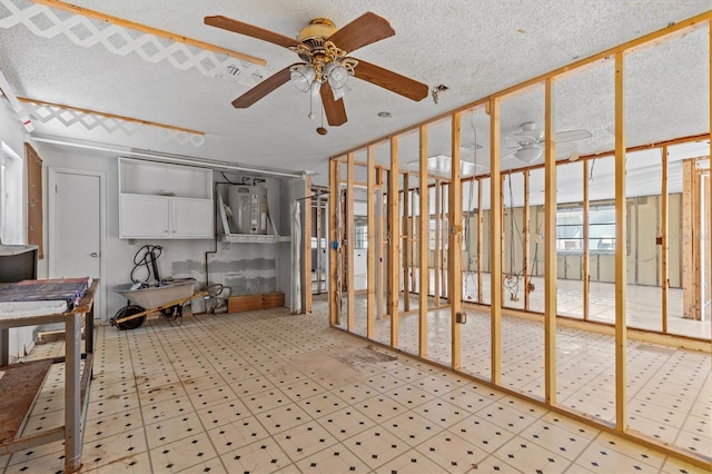 13815 Plumosa Ave, Hudson, FL 34667 - interior space featuring a textured ceiling, a ceiling fan, electric water heater, and tile patterned floors