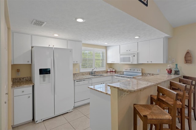 11274 W Cove Harbor Dr Unit 11274, Crystal River, FL 34428 - kitchen featuring white appliances, a peninsula, a sink, white cabinets, and light tile patterned floors
