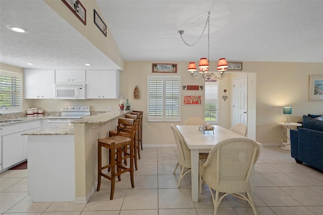 11274 W Cove Harbor Dr Unit 11274, Crystal River, FL 34428 - dining area with a chandelier, light tile patterned floors, baseboards, and recessed lighting