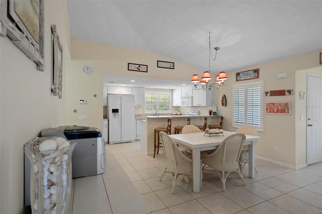 11274 W Cove Harbor Dr Unit 11274, Crystal River, FL 34428 - dining room with lofted ceiling, light tile patterned floors, and a chandelier