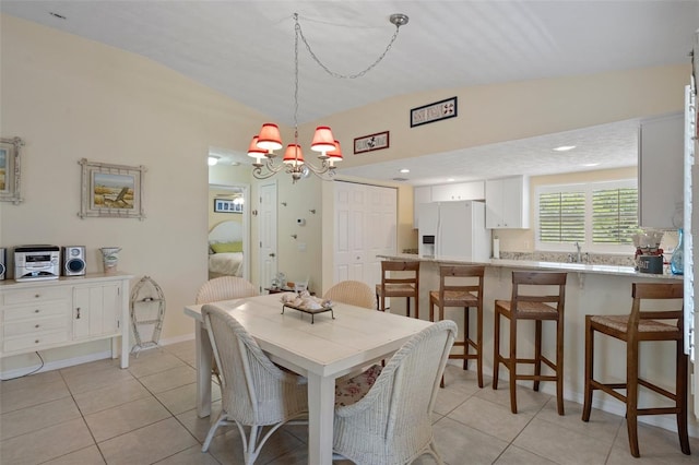 11274 W Cove Harbor Dr Unit 11274, Crystal River, FL 34428 - dining space featuring lofted ceiling, light tile patterned floors, and a chandelier