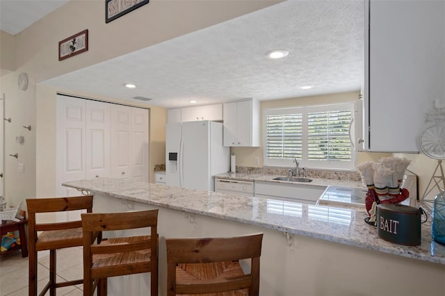 11274 W Cove Harbor Dr Unit 11274, Crystal River, FL 34428 - kitchen featuring white appliances, a kitchen breakfast bar, white cabinets, a sink, and a textured ceiling