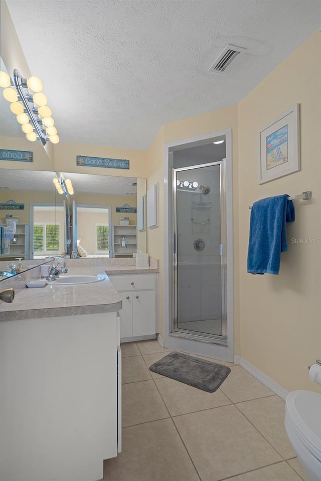 11274 W Cove Harbor Dr Unit 11274, Crystal River, FL 34428 - bathroom featuring a shower stall, a textured ceiling, tile patterned flooring, vanity, and baseboards