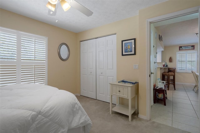 11274 W Cove Harbor Dr Unit 11274, Crystal River, FL 34428 - bedroom with baseboards, a closet, a ceiling fan, and light colored carpet