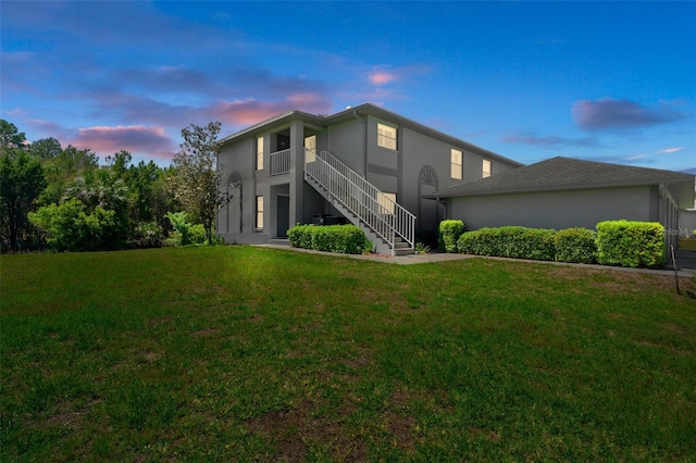 11274 W Cove Harbor Dr Unit 11274, Crystal River, FL 34428 - view of side of property featuring stucco siding, stairway, and a lawn