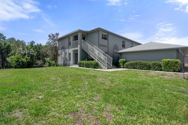 11274 W Cove Harbor Dr Unit 11274, Crystal River, FL 34428 - rear view of property with stucco siding, stairway, and a yard
