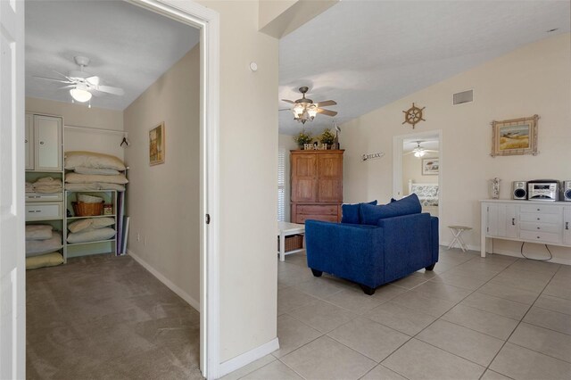 11274 W Cove Harbor Dr Unit 11274, Crystal River, FL 34428 - living area featuring a ceiling fan, baseboards, light tile patterned floors, and lofted ceiling