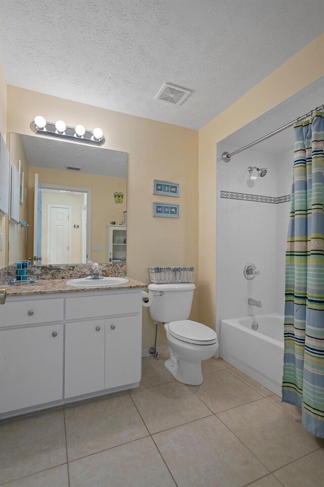 11274 W Cove Harbor Dr Unit 11274, Crystal River, FL 34428 - full bathroom featuring tile patterned flooring, vanity, toilet, shower / tub combo with curtain, and a textured ceiling