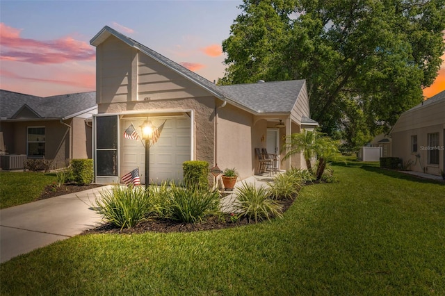 view of front of house featuring concrete driveway, stucco siding, cooling unit, a garage, and a lawn
