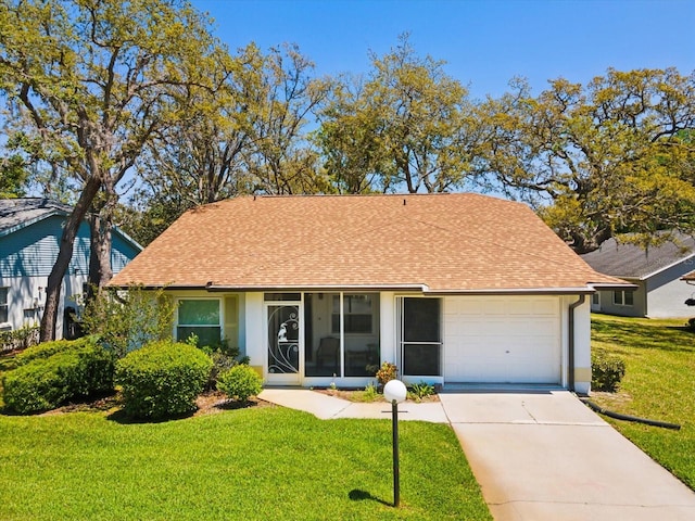 11536 Golden Rain Dr, New Port Richey, FL 34654 - view of front of home with a garage, a shingled roof, driveway, and a front yard