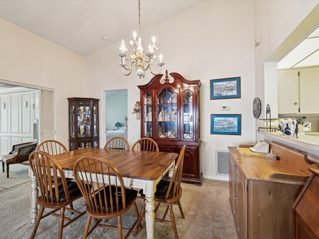 11536 Golden Rain Dr, New Port Richey, FL 34654 - dining area featuring light carpet, high vaulted ceiling, and a chandelier