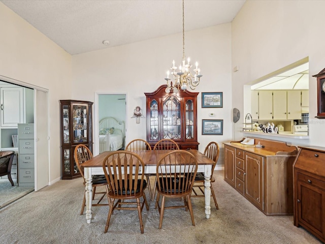 11536 Golden Rain Dr, New Port Richey, FL 34654 - dining room with high vaulted ceiling, light carpet, and a chandelier